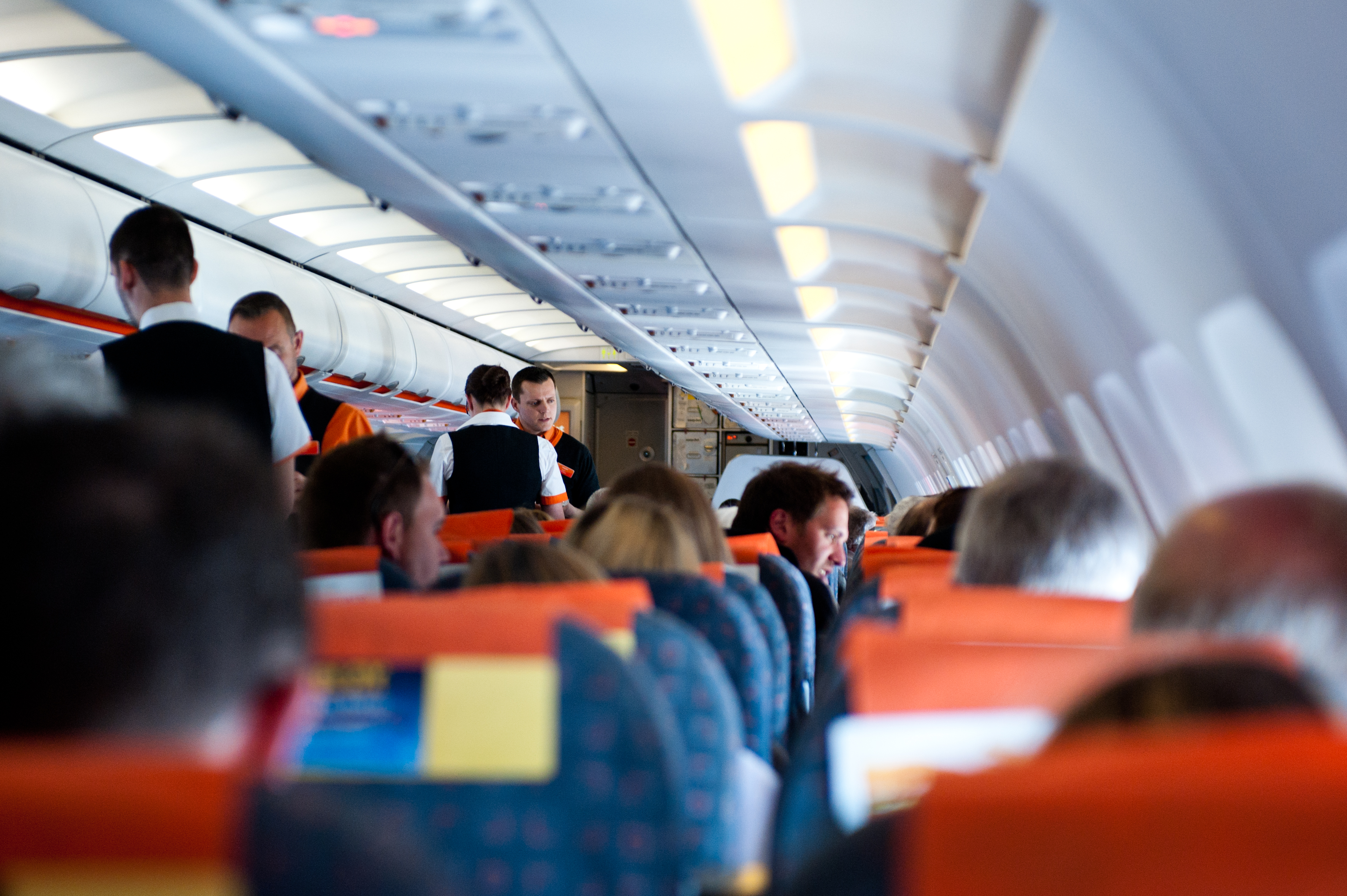 A photo of flight attendants serving passengers.